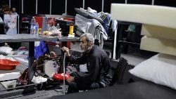 A man sits in a makeshift shelter after being displaced from his home in Lebanon 