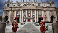 Images of the fourteen new saints are hung on the facade of Saint Peter's Basilica