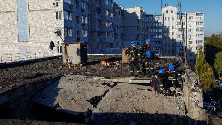 Equipes de resgate trabalham no telhado de um prédio de apartamentos danificado durante um ataque de drone russo na cidade de Hlevakha, em meio ao ataque da Rússia à Ucrânia, na região de Kiev, Ucrânia, em 21 de outubro de 2024. REUTERS/Valentyn Ogirenko