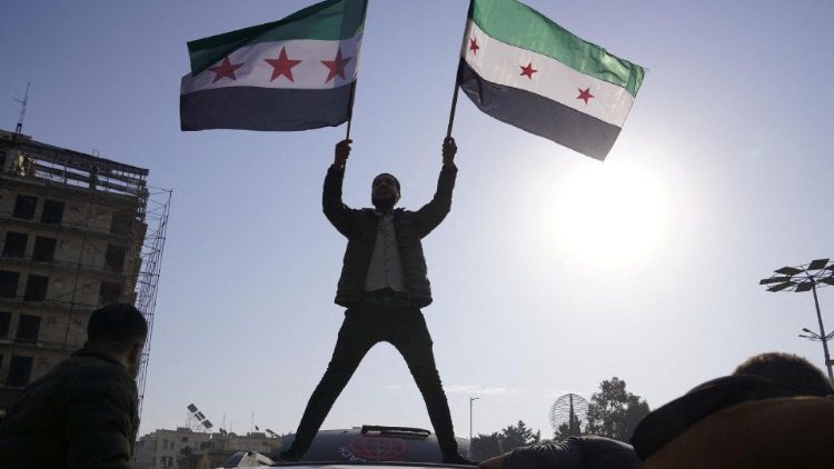 People celebrate in Aleppo after the removal of President Bashar al-Assad