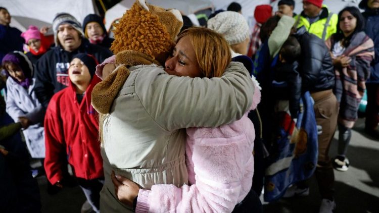 Migrants wait and pray in a temporary shelter in Matamoros, Mexico