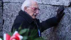 A survivor at the Death Wall during a ceremony marking the 80th anniversary of the liberation of the Nazi German Auschwitz-Birkenau concentration camp