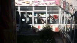 People queue at a polling station in Pristina as Kosovo holds parliamentary elections.
