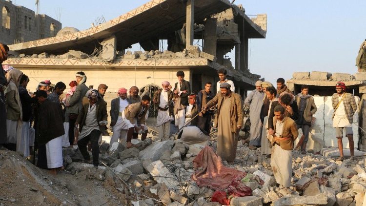 People gather on the rubble of a house hit by a U.S. strike in Saada