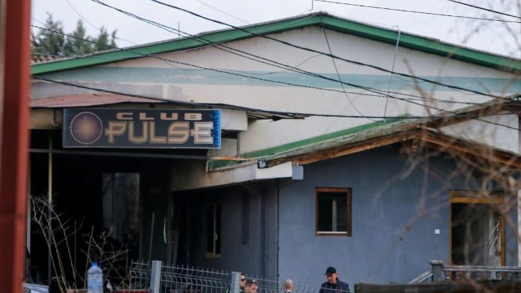 Rescue crews operate outside a night club, following a fire resulting in casualties, in the town of Kocani