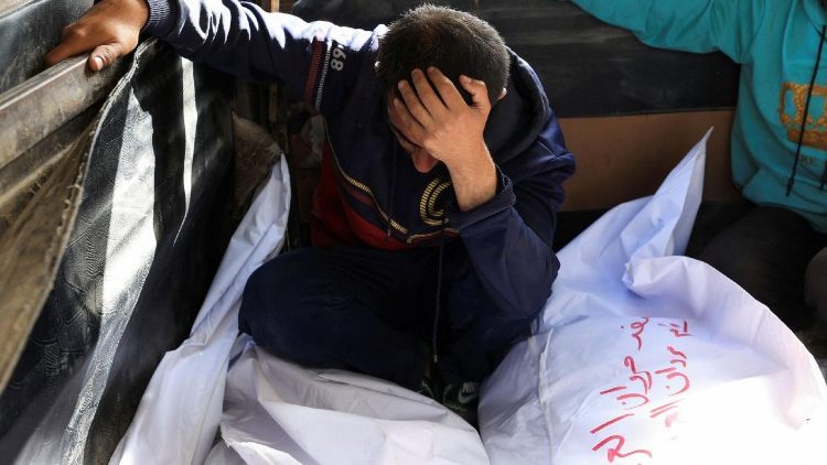 A mourner reacts besides the bodies of members of the Al-Arabeed family killed in Israeli strikes, at Al Shifa hospital, in Gaza City