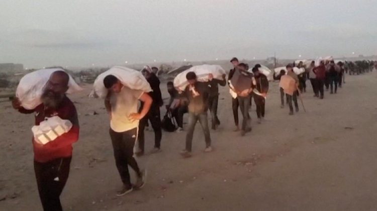 Palestinians carry aid supplies received from the U.S.-backed Gaza Humanitarian Foundation, in Rafah