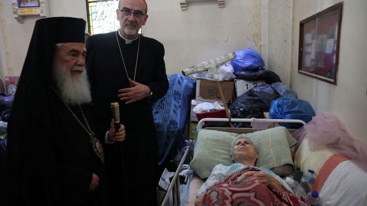 Cardinal Pierbattista Pizzaballa (C) and Greek Orthodox Patriarch of Jerusalem, Theophilos III, visit the Church of the Holy Family in Gaza City
