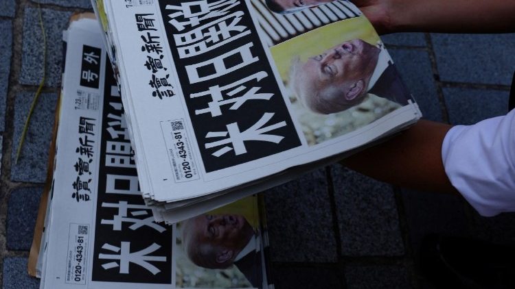 A staff from Yomiuri Shimbun newspaper prepares to distribute a special edition of the newspaper reporting the tariff deal agreement between U.S and Japan, in Tokyo