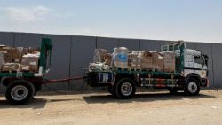 A truck carrying humanitarian aid stands near the Rafah border crossing between Egypt and the Gaza Strip, in Rafah on 11 August