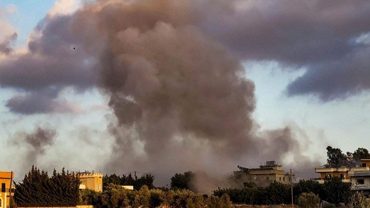 Smoke billows over Kfar Tebnit after an Israeli strike near Lebanon’s border with Israel