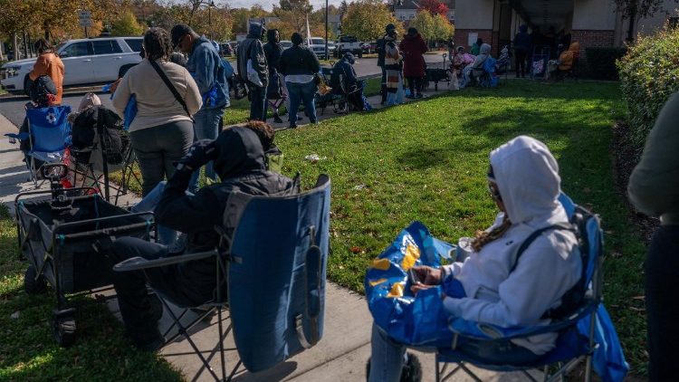 Federal employees line up before collecting food from a Capital Area Food Bank distribution center as the U.S. government shutdown continues in Hyattsville, Maryland