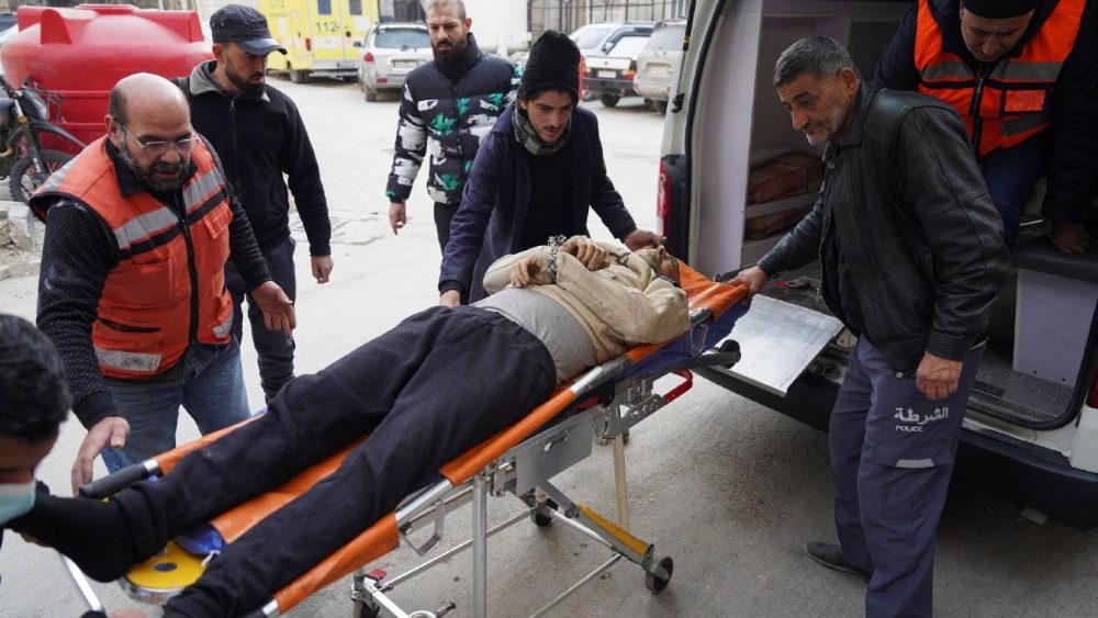 An injured man lies on a stretcher following renewed clashes between the Syrian army and the Syrian Democratic Forces