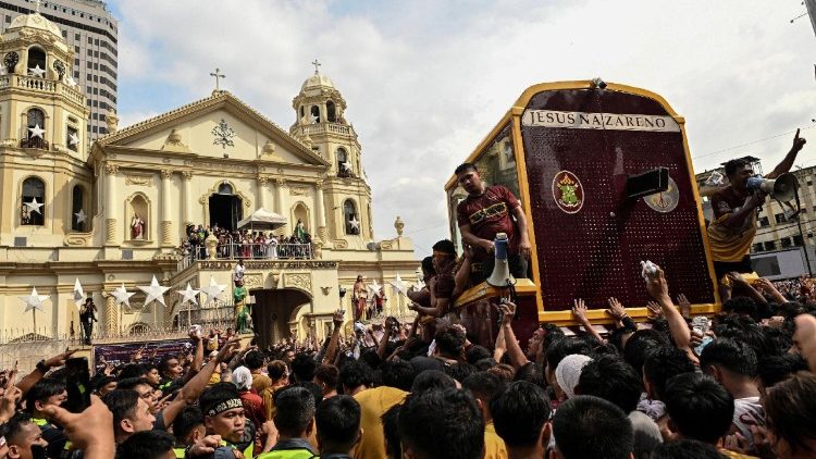 Cientos de personas rodean a la imagen del Cristo Nazareno mientras es llevada en procesión