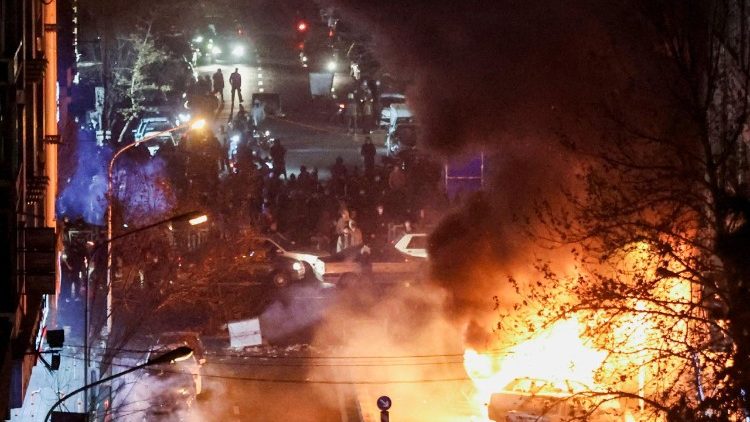 Cars burn in a street during a protest over the collapse of the currency's value, in Tehran