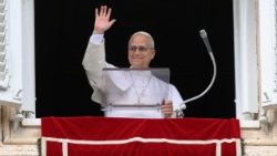 Pope Leo XIV waves, on the day he leads the Angelus prayer from a window of the Apostolic Palace, at the Vatican