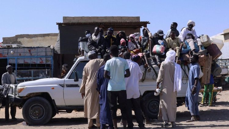 FILE PHOTO: People prepare to travel about 250 km south to Adre, on the Chad-Sudan border, at a transport station in Tine