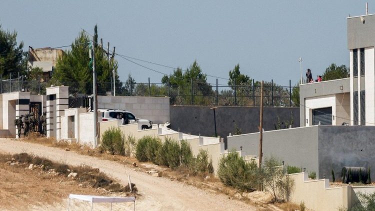 International convoy delivers aid to Palestinian families after Israeli army checks them, on the outskirts of Qusra village in the West Bank