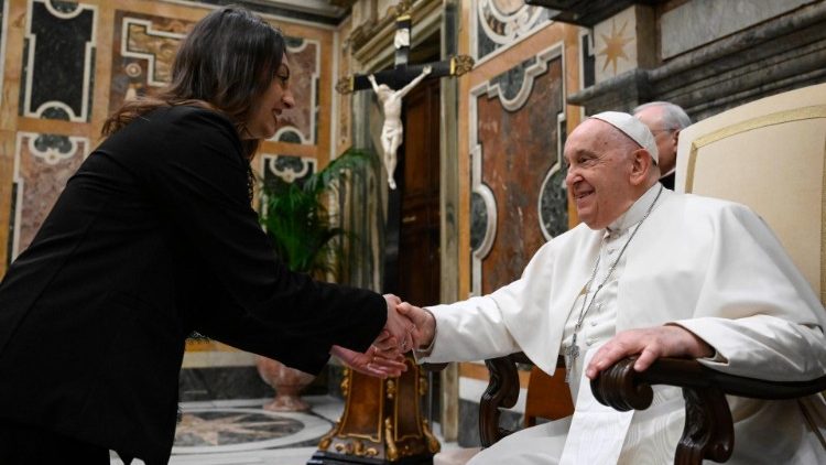 Pope Francis greets a participant in the event