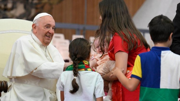 Pope Francis greets choristers in an audience in the Vatican's Paul VI Hall