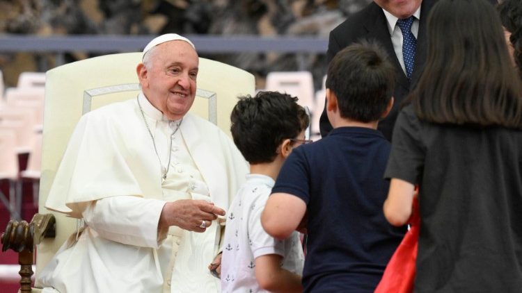 Pope Francis greets choristers in an audience in the Vatican's Paul VI Hall