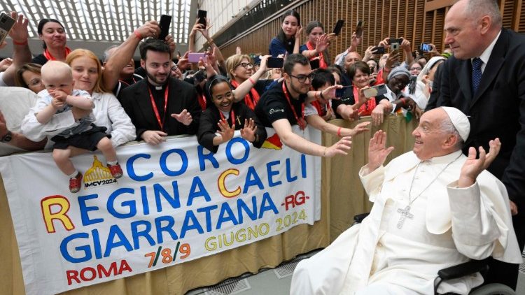 Pope Francis greets choristers at an audience in the Paul VI Hall