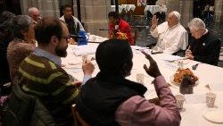 Pope Francis has breakfast with several poor people and refugees in the Church of St. Gilles
