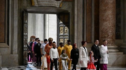 Pilgrims pass through the Holy Door at the beginning of the Jubilee Year