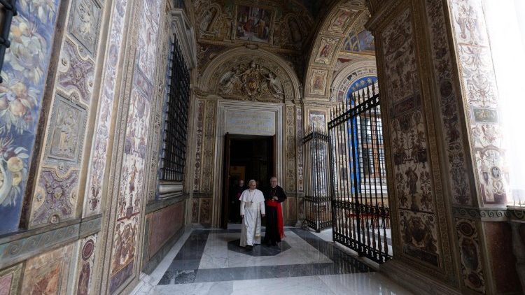 Pope Leo XIV walks in the corridor of the Third Loggia of the Apostolic Palace