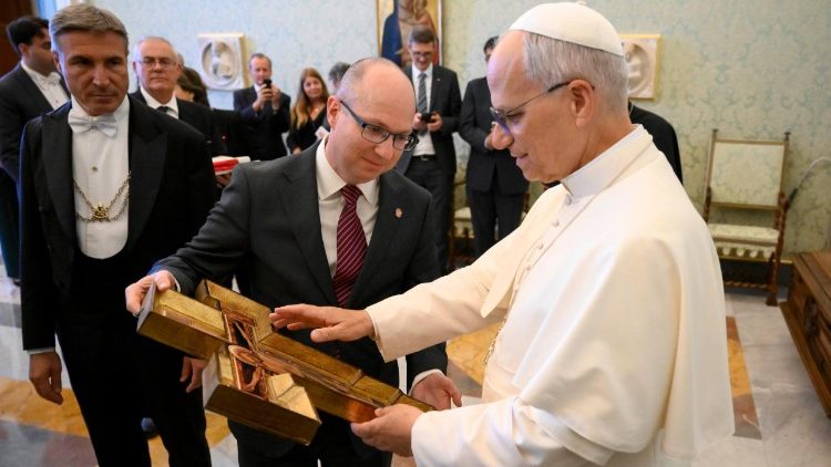 Pope Leo XIV blesses a cross during the audience with Aid to the Church in Need on October 10, 2025