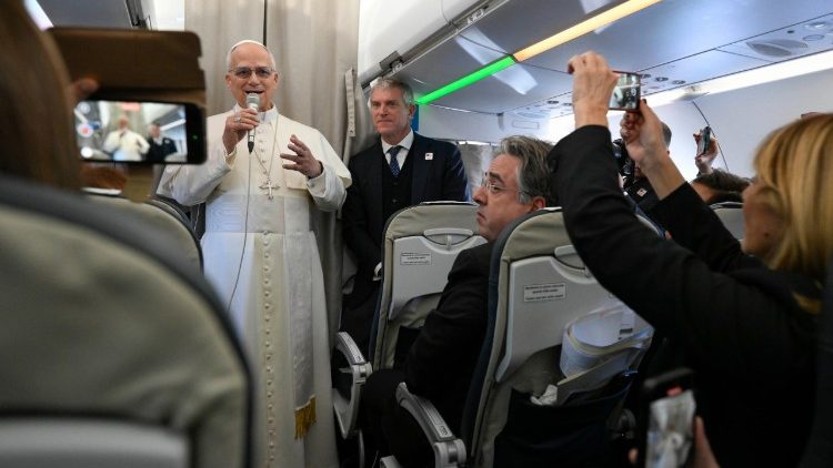 Pope Leo greets journalists aboard the papal plane bound for Ankara, Türkiye