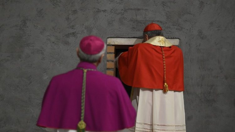 Cardinal Gambetti places the bronze capsa in the Holy Door