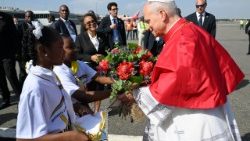 Two children welcome Pope Leo to Angola with a bouquet of flowers