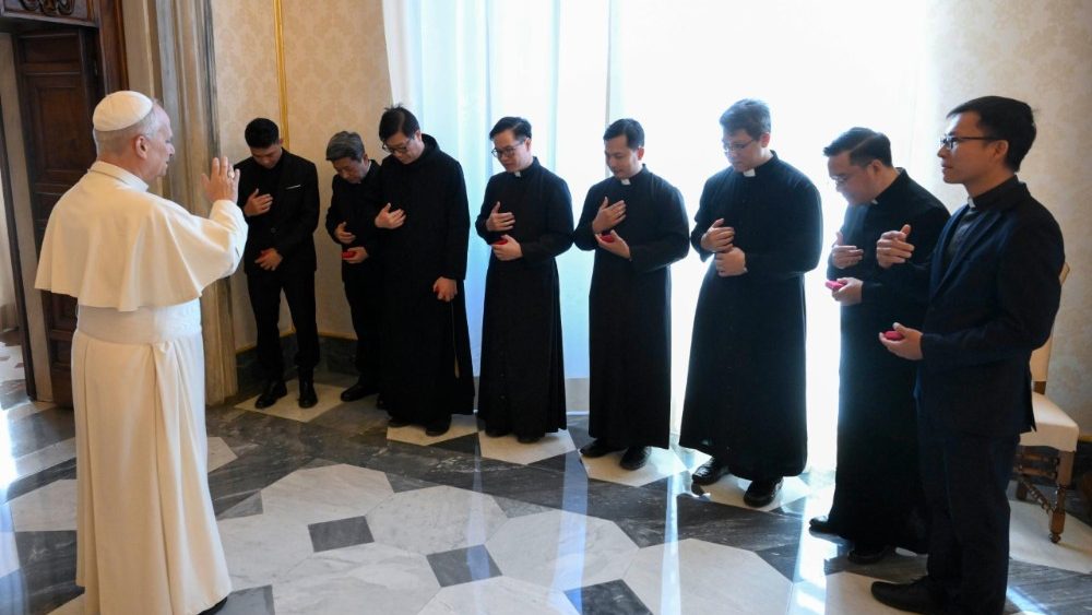 The Pope extending his blessing on the bishops