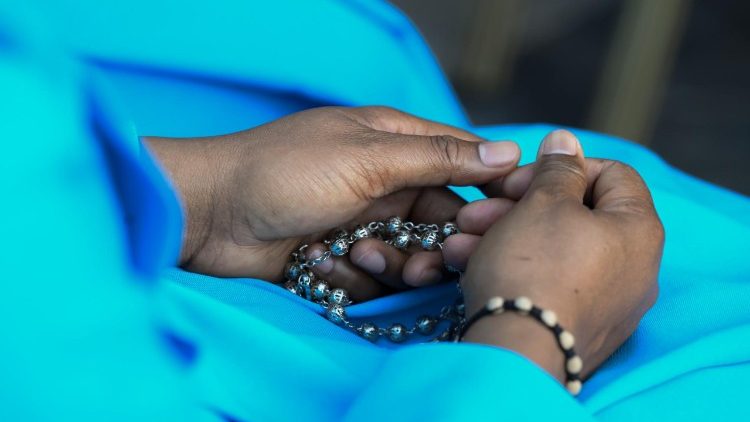 A pilgrim praying with the Pope in the Vatican Gardens