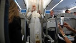 Pope Leo XIV greets journalists aboard the papal plane
