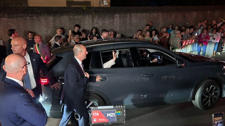 Pope Leo waves from his car as he returns to the Vatican