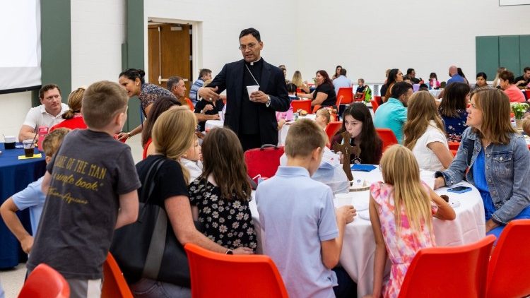 Bishop Fernandes speaks with families at the opening of Ave Maria Academy, the first parochial school to open in the diocese in 30 years