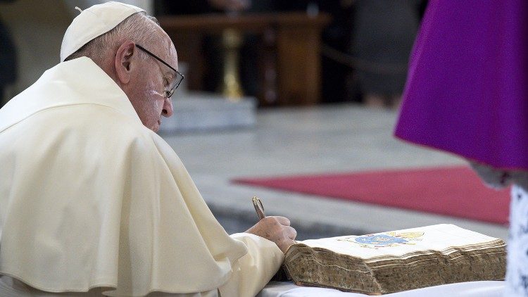 File photo of Pope Francis writing