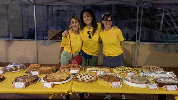 Members of the family group surrounded by cakes prepared for the parish feast