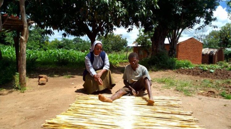Sr. Bernardette Mnyenyembe making mats with one of the beneficiaries of the initiative