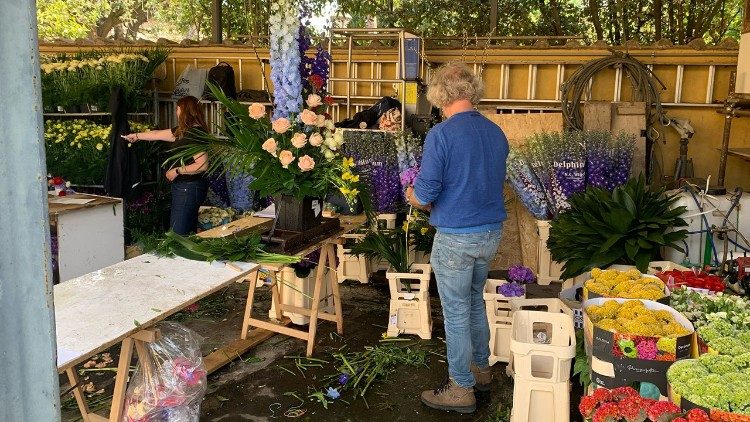 Volunteers prepare the arrangements of 10,000 stems of flowers driven in from the Netherlands for the Easter celebrations at the Vatican.