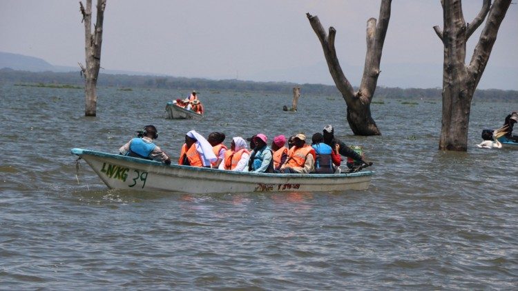 Mumbua offers pastoral care to fishermen aboard a moving boat during her visit to Lake Naivasha