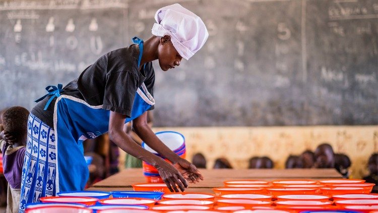 A volunteer helps to prepare meals for children in Turkana, Northern Kenya