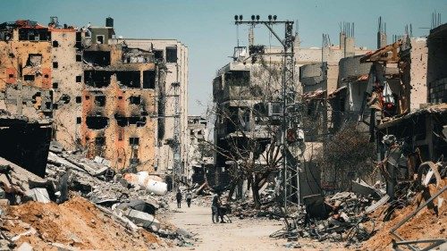 Palestinians walk amid the destruction of Gaza