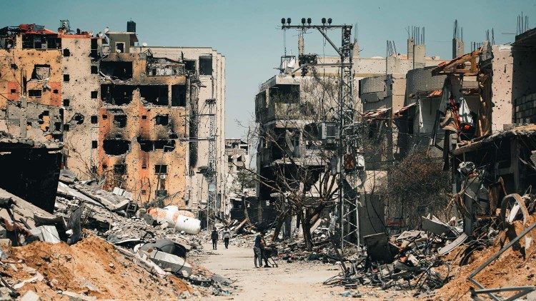 Palestinians walk amid the destruction of Gaza