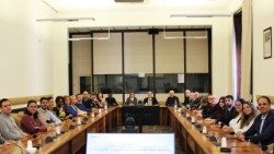 The staff and superiors of the Dicastery for Promoting Integral Human Development in the conference room of its offices at Palazzo San Calisto