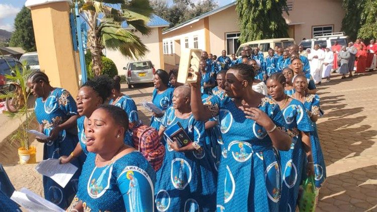Tanzanian Catholic faithful sing as they take part in a procession