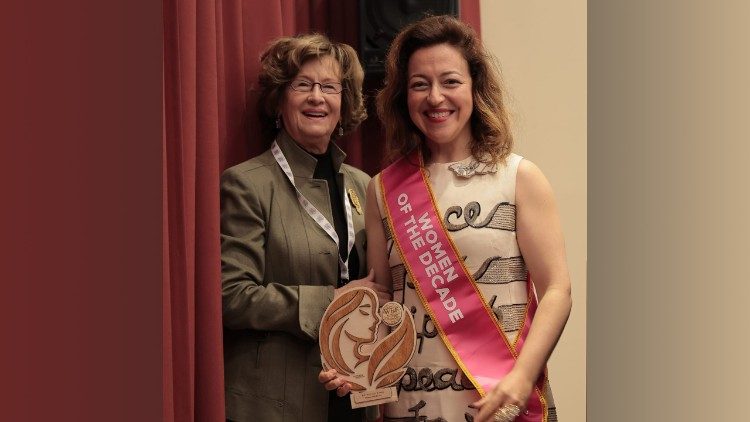 Guila Clara Kessous at the award ceremony wearing "The Peace Dress", next to Marilena Citelli Francese, Director of the Women Economic Forum Italy
