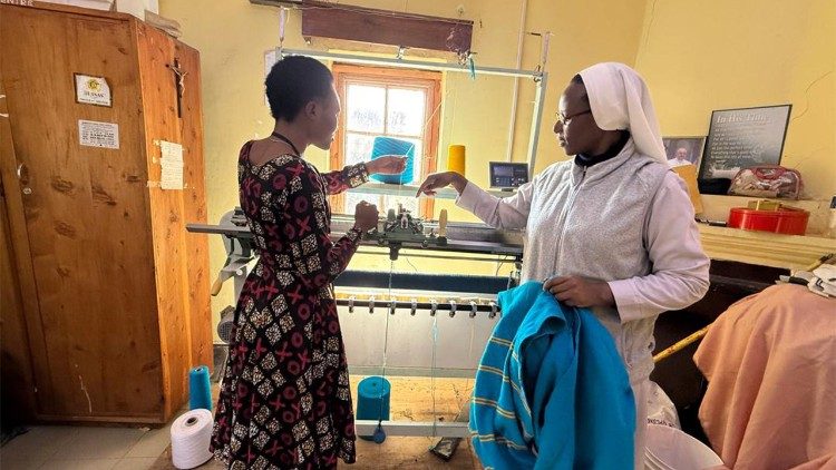 La responsable del Centro de formación santa Magdalena, sor Levina Mzebele, enseña a una chica el uso de la máquina avanzada para hacer jerséis.